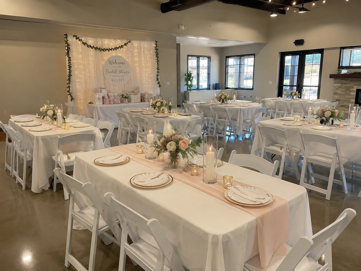 Bridal shower tables and chairs with floral centerpieces and soft pink accents