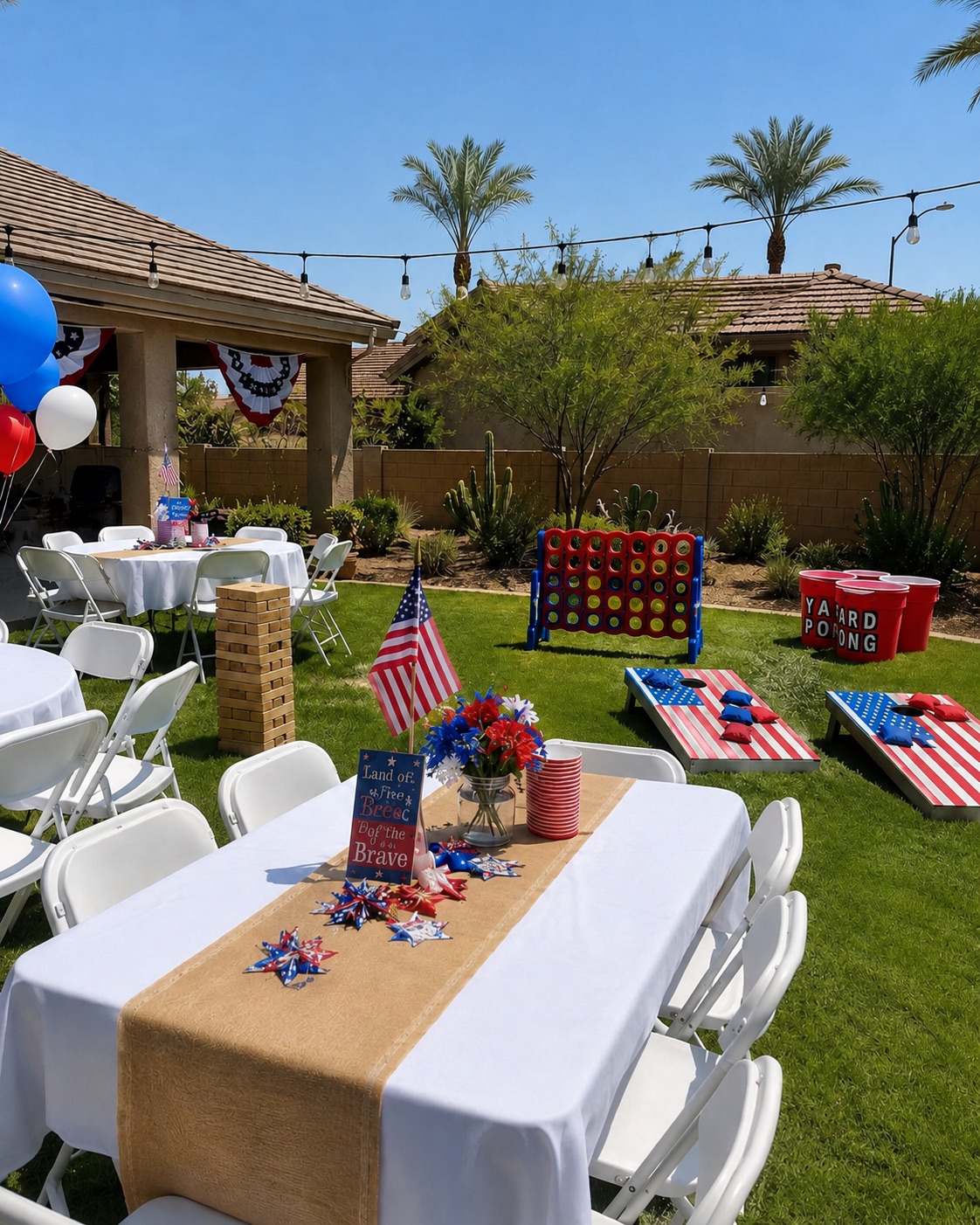 Giant Jenga tower set up with tables, chairs, and other yard games at an Arizona backyard event